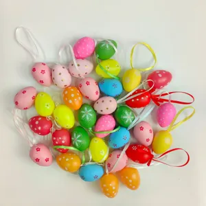 Detailed view of multiple colorful painted plastic Easter eggs with hanging ribbons