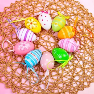 Set of twelve colorful patterned Easter eggs with hanging ribbons for festive home decor.