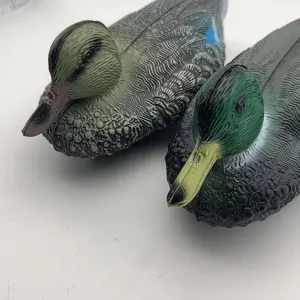 Detailed close-up of realistic plastic mallard decoys for outdoor garden decoration