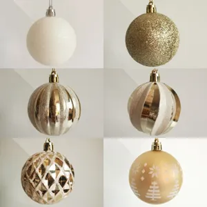 Close-up detail of 6 different gold and white 6cm Christmas ball ornaments for tree decoration