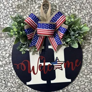 Detail showing the patriotic wooden door sign with a flag patterned bow and Welcome text.