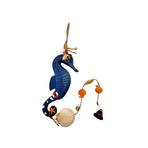 Detail of Mediterranean seahorse wind chime with decorative shells and bell for garden decor.
