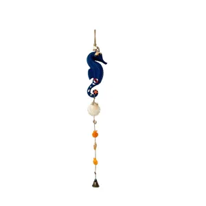 Mediterranean style seahorse wind chime with natural shells and metal bell detail