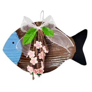 Detailed view of Mediterranean wooden fish ornament with pink flowers and ribbon