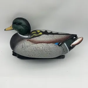 Side view of a realistic plastic mallard duck decoy for garden or pond decoration.