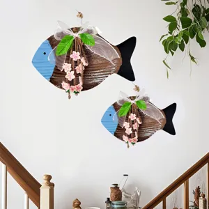Mediterranean style fish wall hanging with white bow and pink flower details for home.
