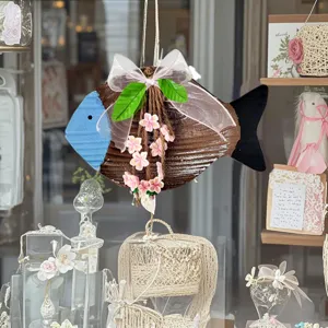 Rustic Mediterranean fish hanging decoration with a white mesh bow and pink cherry blossoms