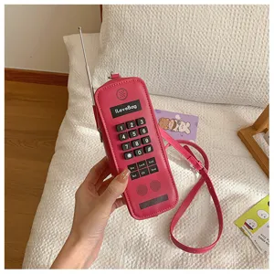 Detailed macro view of a creative pink retro brick phone shaped novelty crossbody bag for women