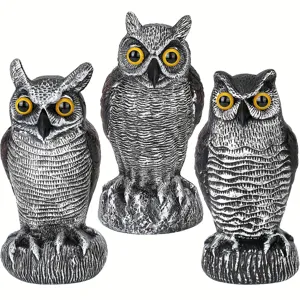 Set of three realistic plastic owl decoys for garden bird scaring on white background