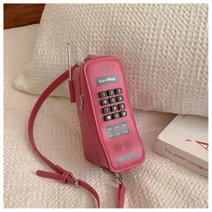 Detailed view of a creative pink retro brick mobile phone shaped novelty crossbody bag