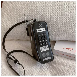 Macro view of creative retro mobile phone shaped crossbody bag with realistic keypad details