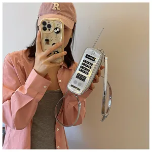 Detailed macro view of nostalgic silver mobile phone shaped crossbody bag with antenna