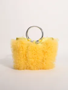 Close-up of yellow ruffled tulle texture and silver metallic ring handle on a stylish bag.