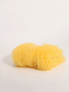 Detailed view of yellow ruffled tulle handbag featuring layered pleated mesh texture