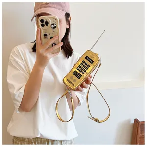 Creative retro big brother mobile phone shaped gold crossbody bag worn by model detail view