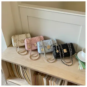 Stylish quilted faux leather chain flap bags in four colors displayed on a wooden shelf