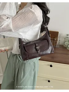 Vintage dark brown oil wax leather underarm bag with front buckle pocket design.