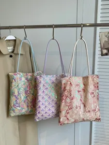 Set of three colorful women's shoulder bags with geometric sequin embroidery patterns