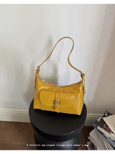 Minimalist vintage yellow oil wax leather shoulder bag with an elegant buckle pocket design