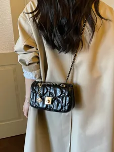 Black quilted leather crossbody bag with chain strap and gold hardware for women.