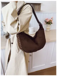 Brown suede hobo bag detail showcasing retro metal rivets and soft slouchy design.