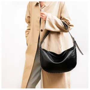 Detailed shot of a black PU leather hobo bag featuring stylish metal studs along the strap.