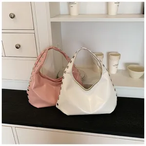 Glossy PU underarm bags in pink and white with metal rivet detailing on the straps.