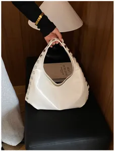 Side view of a glossy white PU shoulder bag featuring punk-style silver rivet details