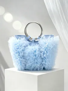 Detailed shot of a light blue ruffled pleated handbag with a metal ring handle