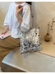 Detailed macro view of a stylish silver sequin tote bag in a lifestyle setting