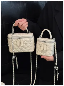 Cream quilted box bags with pearls and rhinestones shown in two different sizes comparison