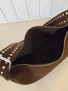 Brown suede hobo shoulder bag for women with chic metal studs, slouchy dumpling bag design.