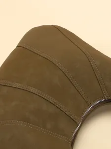 Détail d'un sac demi-lune marron matelassé montrant la texture des coutures et le zip