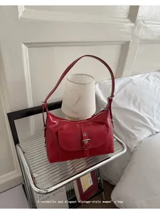 Vintage red oil-wax leather shoulder bag with buckle pocket detail