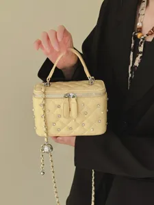Elegant yellow quilted box bag decorated with pearls and crystals with chain strap
