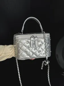 Elegant silver quilted box bag featuring pearl and rhinestone embellishments with chain strap