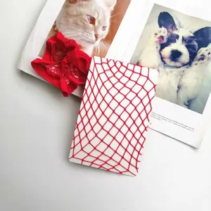 Red fishnet stockings with large mesh design shown on a white background