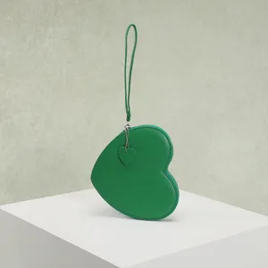 Detailed view of a green heart-shaped coin purse with a matching heart zipper charm