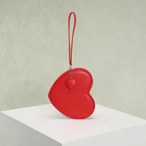 Detailed view of a red heart-shaped coin purse featuring a matching heart zipper pendant