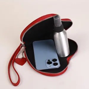 Internal view of a red heart-shaped coin purse showing capacity for a phone and bottle.