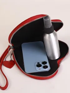 Fashion heart-shaped red wristlet coin purse showing interior capacity and smartphone