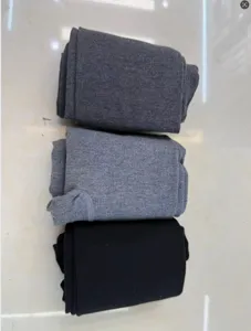 Detailed macro view of high elastic ribbed cotton leggings in grey and black shades