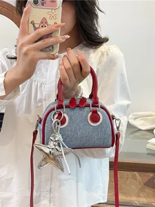 Stylish denim colorblock bowling bag with red trim and silver star charm for women