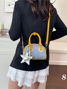 Trendy denim colorblock bowling handbag with a stylish silver star charm accessory