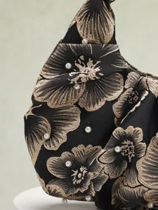 Dettaglio macro di una borsa cinese vintage con ricami floreali dorati e perle