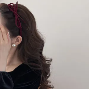 Elegant vintage burgundy velvet bow headband creating a high-cranial top effect for women