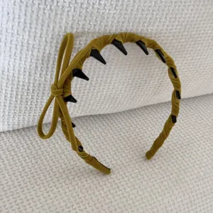 Detailed view of a stylish mustard yellow flocked bow headband featuring anti-slip teeth design