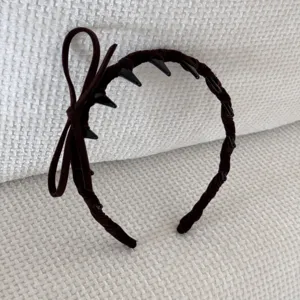 Detailed view of coffee brown velvet headband with delicate bow and anti-slip teeth