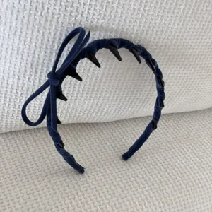 Detailed view of a blue velvet headband with a decorative side bow and anti-slip teeth