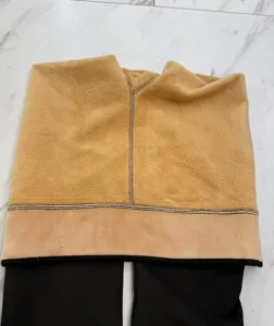 Detailed view of the thick camel fleece lining inside black thermal winter leggings artifact
